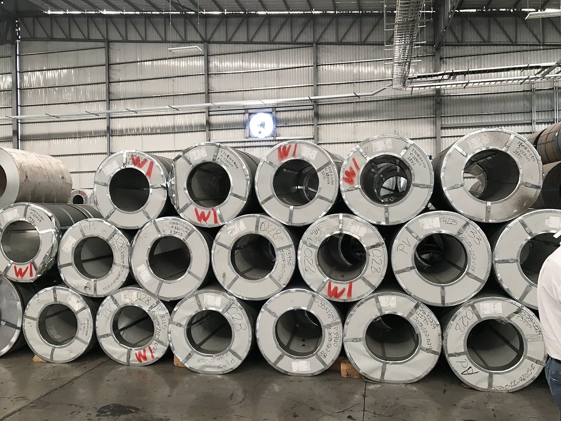 Coils of sheet steel stacked in a warehouse