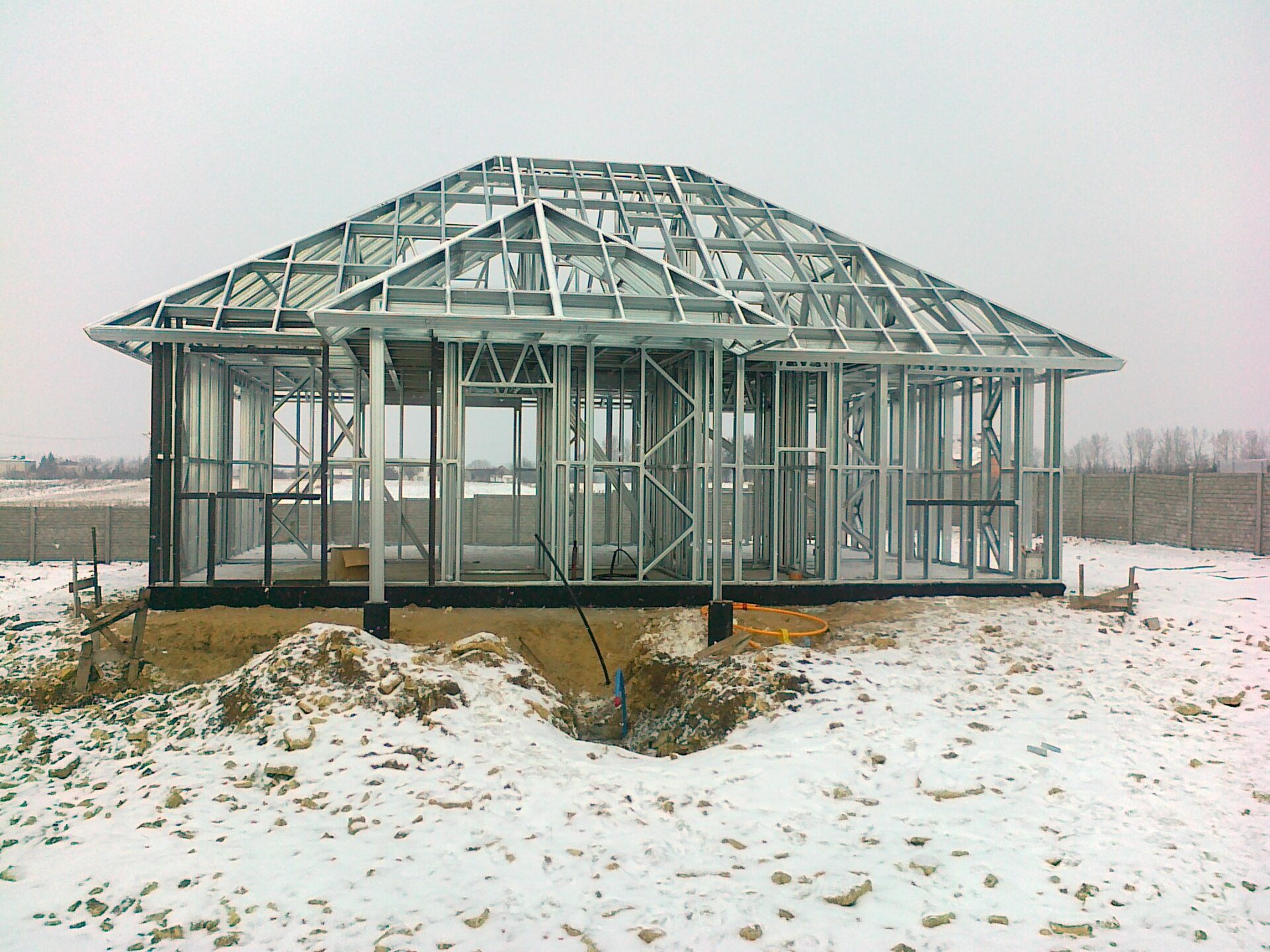 Light gauge steel house frame on a snowy site